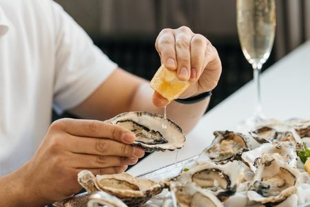 Healthy man with testosterone-boosting foods like oysters, spinach, and eggs