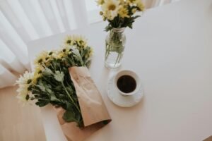 cup of coffee with bouquet of flowers at breakfast